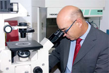 Dr. Luis Izquierdo at the microscope